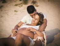 Happy Pregnant couple on beach